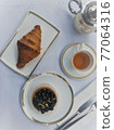 Top view of afternoon tea table. Soft focus with white flare filter. 77064316