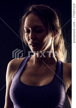 Slim beauty athletic woman on black background Slim beauty athletic woman on black background 77065320