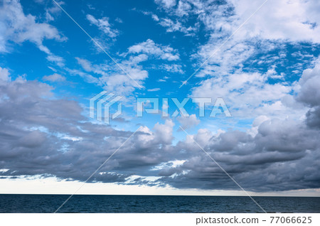 Cloudy on blue sky over the sea Cloudy on blue sky over the sea 77066625
