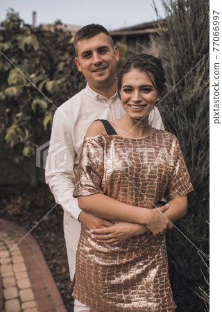 couple of lovers in festive fashionable clothes are hugging couple of lovers in festive fashionable clothes are hugging 77066997