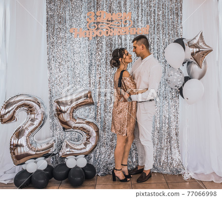 inscription: happy birthday. couple in festive fashionable clothes 77066998