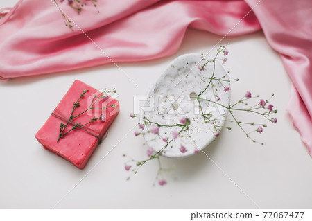 Spa composition with pink soap bar with ceramic soap dish, silk babric and flowers Spa composition with pink soap bar with ceramic soap dish, silk babric and flowers 77067477