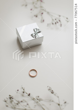 Golden ring and jewelry box and flowers. Wedding, Love, Valentine's day, Happy Birthday, Proposal of marriage concept 77067514
