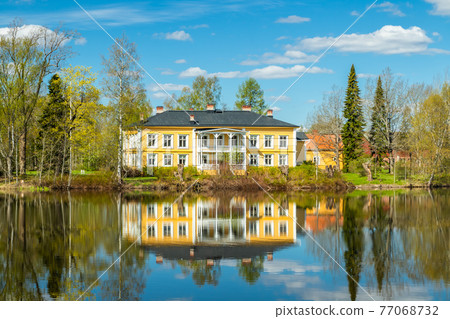 Kouvola, Finland - May 16, 2019: Beautiful wooden Rabbelugn Manor - Takamaan Kartano. Wrede family house was built in 1820 on the river Kymijoki bank. 77068732