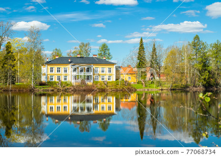 Kouvola, Finland - May 16, 2019: Beautiful wooden Rabbelugn Manor - Takamaan Kartano. Wrede family house was built in 1820 on the river Kymijoki bank. 77068734