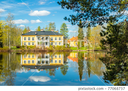 Kouvola, Finland - May 16, 2019: Beautiful wooden Rabbelugn Manor - Takamaan Kartano. Wrede family house was built in 1820 on the river Kymijoki bank. 77068737