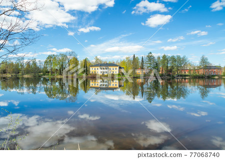 Kouvola, Finland - May 16, 2019: Beautiful wooden Rabbelugn Manor - Takamaan Kartano. Wrede family house was built in 1820 on the river Kymijoki bank. Kouvola, Finland - May 16, 2019: Beautiful wooden Rabbelugn Manor - Takamaan Kartano. Wrede family house was built in 1820 on the river Kymijoki bank. 77068740