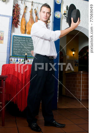 Flamenco dancer from Seville in Spain dancing in a typical Spanish venue Flamenco dancer from Seville in Spain dancing in a typical Spanish venue 77069049