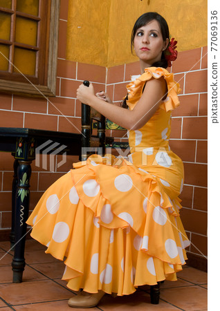Flamenco dancer from Seville in Spain dancing in a typical Spanish venue 77069136
