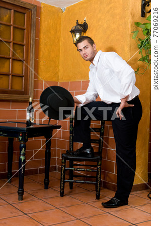 Flamenco dancer from Seville in Spain drinking a wine before dancing in a typical Spanish venue Flamenco dancer from Seville in Spain drinking a wine before dancing in a typical Spanish venue 77069216