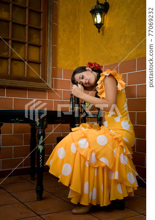 Flamenco dancer from Seville in Spain resting before dancing in a typical Spanish venue 77069232