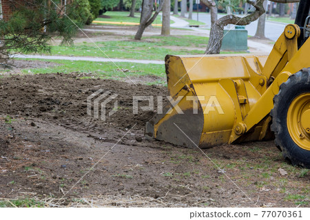 Small tractor digging land working with land Small tractor digging land working with land 77070361