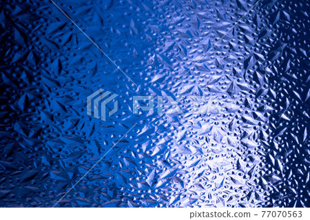 Abstract background of corrugated blue glass.Glass background Abstract background of corrugated blue glass.Glass background 77070563