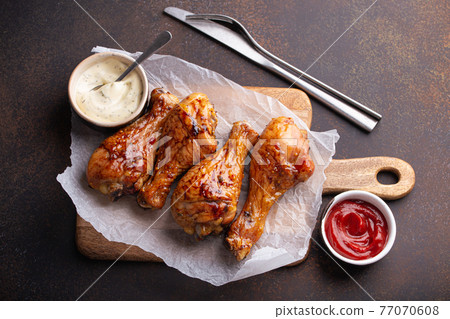 Roasted or grilled chicken legs drumsticks from above Roasted or grilled chicken legs drumsticks from above 77070608