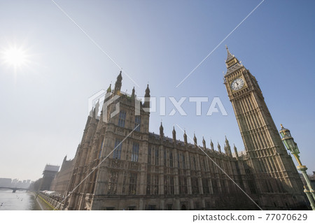 Low angle view of Big Ben and parliament building against clear sky at London; England; UK 77070629
