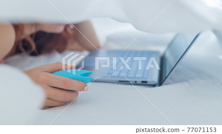 A woman lies in bed holding a clitoral vibrator... - Stock Photo [77071153]  - PIXTA