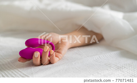 A faceless woman lies in bed under a blanket holding a clitoral vaginal vibrator. The girl masturbates A faceless woman lies in bed under a blanket holding a clitoral vaginal vibrator. The girl masturbates 77071481