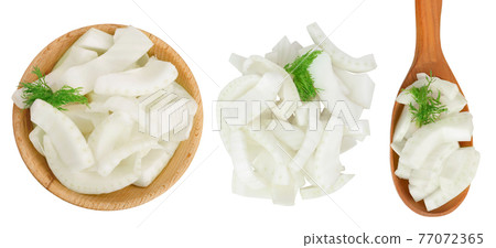 fresh fennel bulb slices in wooden bowl and spoon isolated on white background . Top view. Flat lay fresh fennel bulb slices in wooden bowl and spoon isolated on white background . Top view. Flat lay 77072365