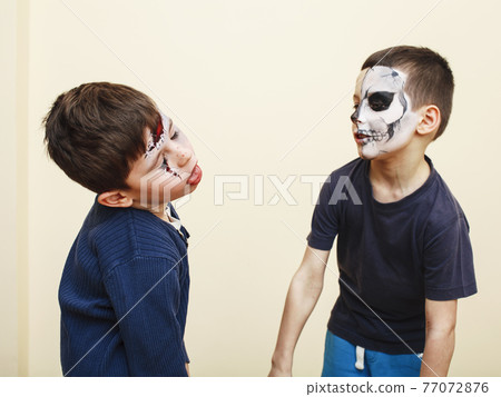 zombie apocalypse kids concept. Halloween party celebration facepaint on  children dead bride, scar face, skeleton together Stock Photo