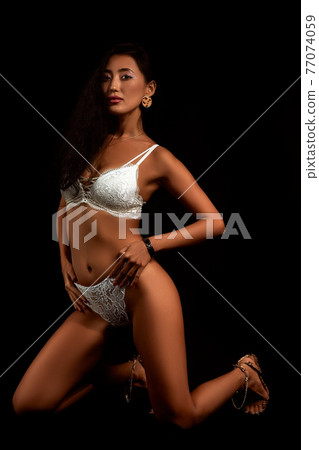 Art nude. Perfect body, sexy girl on the black background Art nude. Perfect body, sexy girl on the black background 77074059