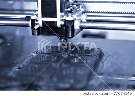 Modern 3D printer printing figure close-up. Automatic three dimensional Modern 3D printer printing figure close-up. Automatic three dimensional 77074149