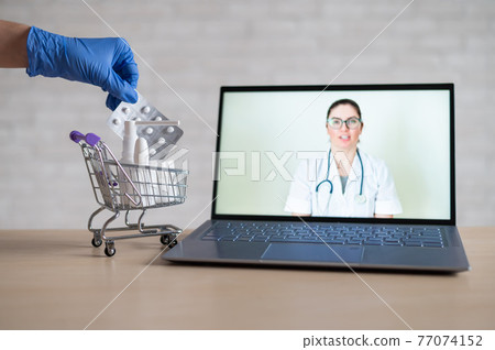 A friendly doctor gives a remote prescription on a laptop. The pharmacist adds a cure for the virus in the mini cart. Online medicine concept. Order drugs online. Video call. A friendly doctor gives a remote prescription on a laptop. The pharmacist adds a cure for the virus in the mini cart. Online medicine concept. Order drugs online. Video call. 77074152