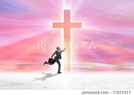 Religious concept with cross and lonely man 77075417