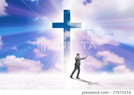 Religious concept with cross and lonely man Religious concept with cross and lonely man 77075418