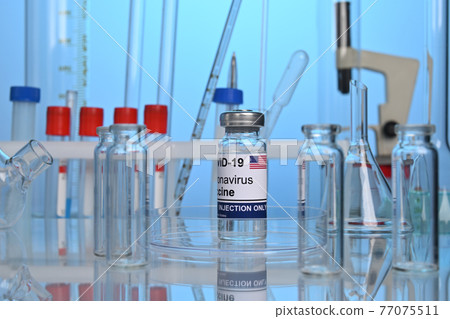 American Covid-19 Vaccine Vial on a Lab Desk American Covid-19 Vaccine Vial on a Lab Desk 77075511