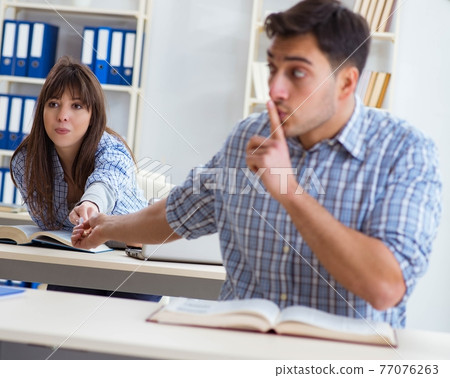 Students sitting and studying in classroom college 77076263