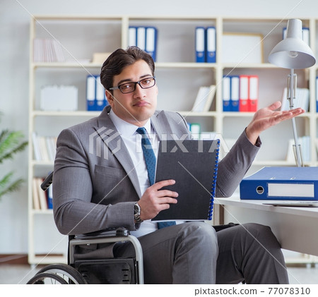 Disabled businessman working in the office 77078310