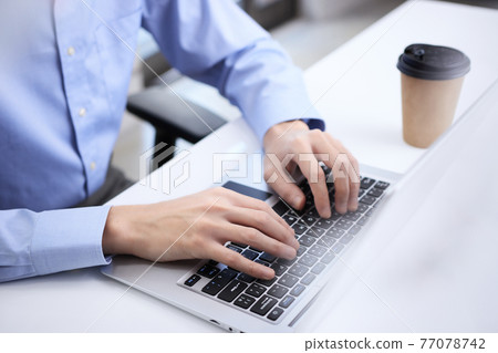 Man working on laptop 77078742