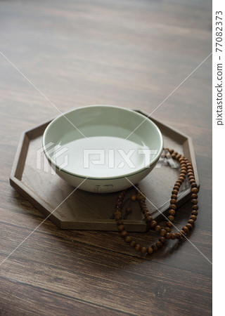 A traditional Korean practice of praying to God with purified water and prayer beads A traditional Korean practice of praying to God with purified water and prayer beads 77082373