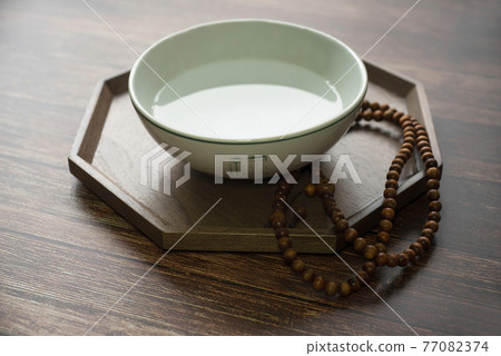 A traditional Korean practice of praying to God with purified water and prayer beads 77082374