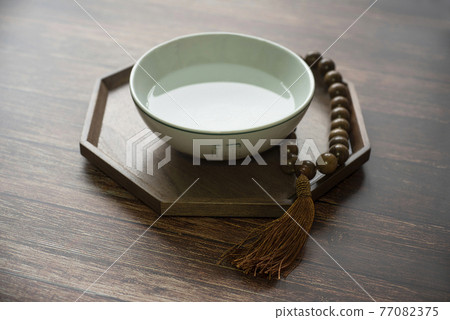 A traditional Korean practice of praying to God with purified water and prayer beads 77082375
