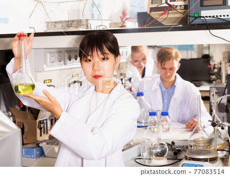 female Chinese chemist working in laboratory 77083514
