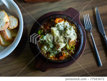 Turkish saute of meat and vegetable with melted cheese and herbs 77083672