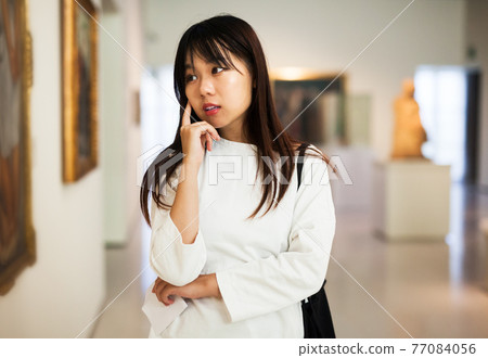 Chinese female visitor in museum Chinese female visitor in museum 77084056
