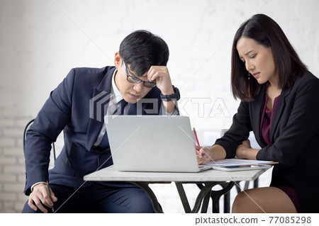 worried and disappointed remote online working man in casual outfit with laptop sitting in an coworking / home office at a work desk worried and disappointed remote online working man in casual outfit with laptop sitting in an coworking / home office at a work desk 77085298