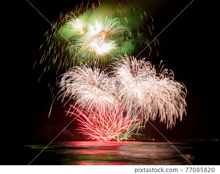 Colorful fireworks reflecting   in the water during  International Fireworks Festival In Forte dei Marmi 77085820