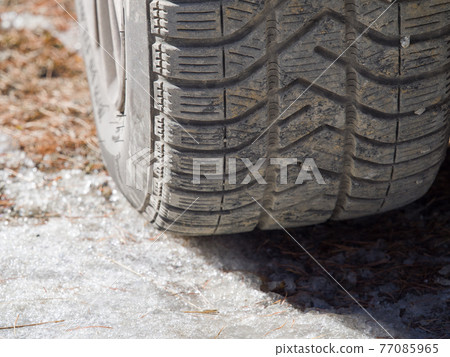 winter tire with peebles in the grooves on ice winter tire with peebles in the grooves on ice 77085965