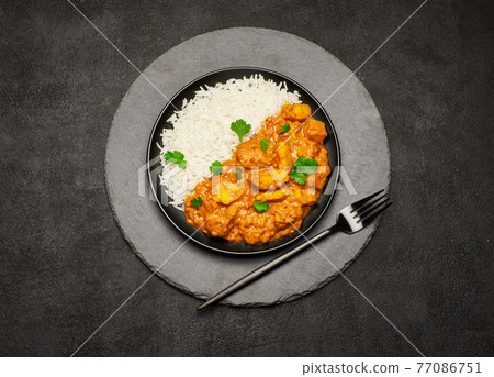 Plate of Traditional Chicken Curry and rice on stone serving board Plate of Traditional Chicken Curry and rice on stone serving board 77086751