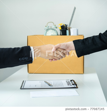 Close up of business woman employee in suit shaking hands with boss after signing on resignation letter 77087145