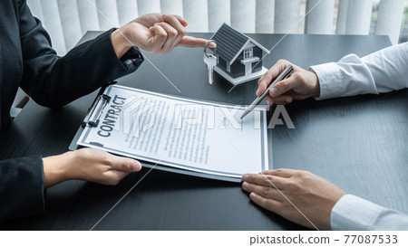 Estate agent giving house and keys to client after signing agreement contract real estate with approved mortgage application form for or house insurance Estate agent giving house and keys to client after signing agreement contract real estate with approved mortgage application form for or house insurance 77087533