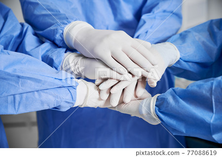 Medical team joining their hands together. Medical team joining their hands together. 77088619
