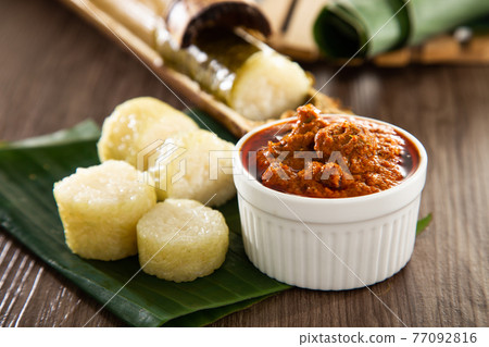 Glutinous rice is wrapped with lerek or banana leaf encased in bamboo culm and cooked in open fire / Lemang / A must have in every traditional Malay household, eaten with beef or chicken rendang Glutinous rice is wrapped with lerek or banana leaf encased in bamboo culm and cooked in open fire / Lemang / A must have in every traditional Malay household, eaten with beef or chicken rendang 77092816
