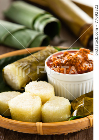 Glutinous rice is wrapped with lerek or banana leaf encased in bamboo culm and cooked in open fire / Lemang / A must have in every traditional Malay household, eaten with beef or chicken rendang Glutinous rice is wrapped with lerek or banana leaf encased in bamboo culm and cooked in open fire / Lemang / A must have in every traditional Malay household, eaten with beef or chicken rendang 77092822