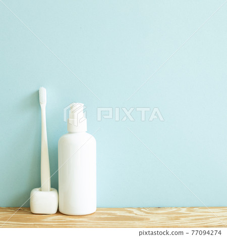 Skin care and spa concept. Bathroom bottle and toothbrush on wooden shelf. sky blue background 77094274