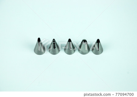 Sets of cream piping nozzles made from stainless steel isolated on white background. It is used to decorate cakes using cream.  77094700