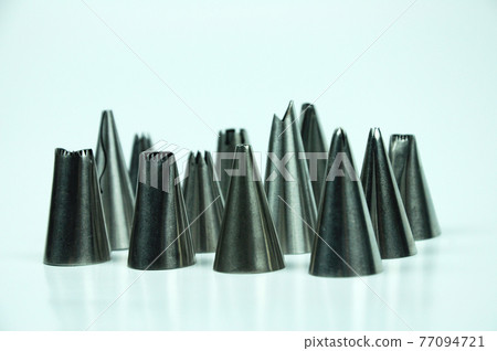 Sets of cream piping nozzles made from stainless steel isolated on white background. It is used to decorate cakes using cream.  77094721